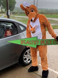 costumed kangaroo and student in a car