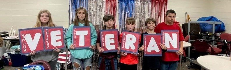 students holding a veteran sign 