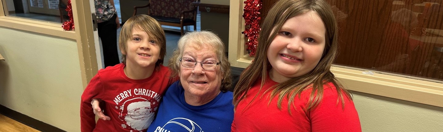 two students with an elderlly woman