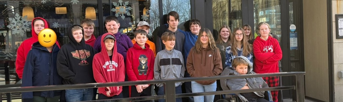 students in front of a restaurant